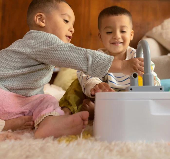 two kids playing with the Lovevery sink