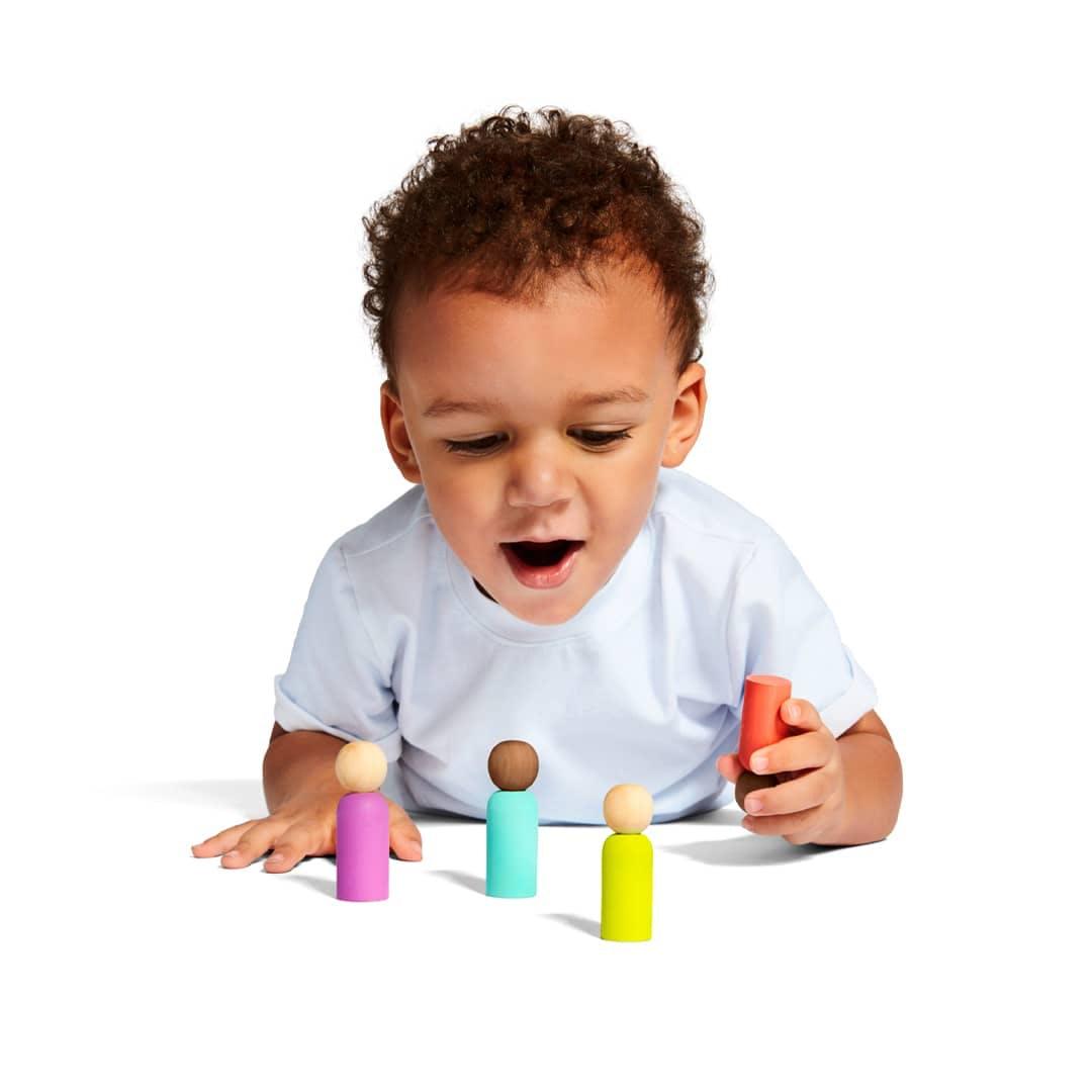 Child playing with peg people image