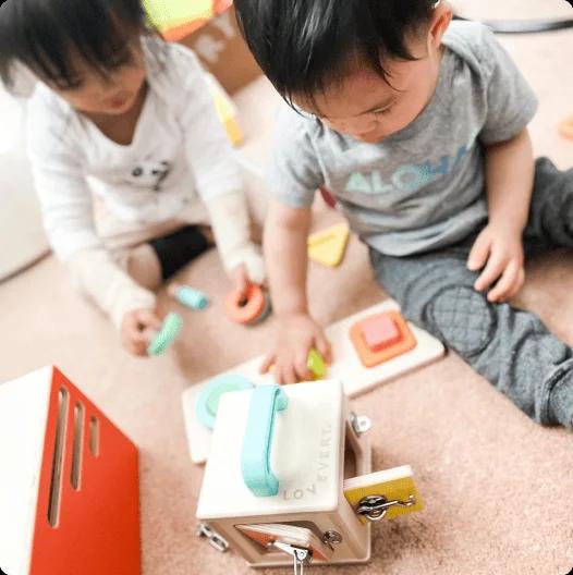 Toddler with toys from The Realist